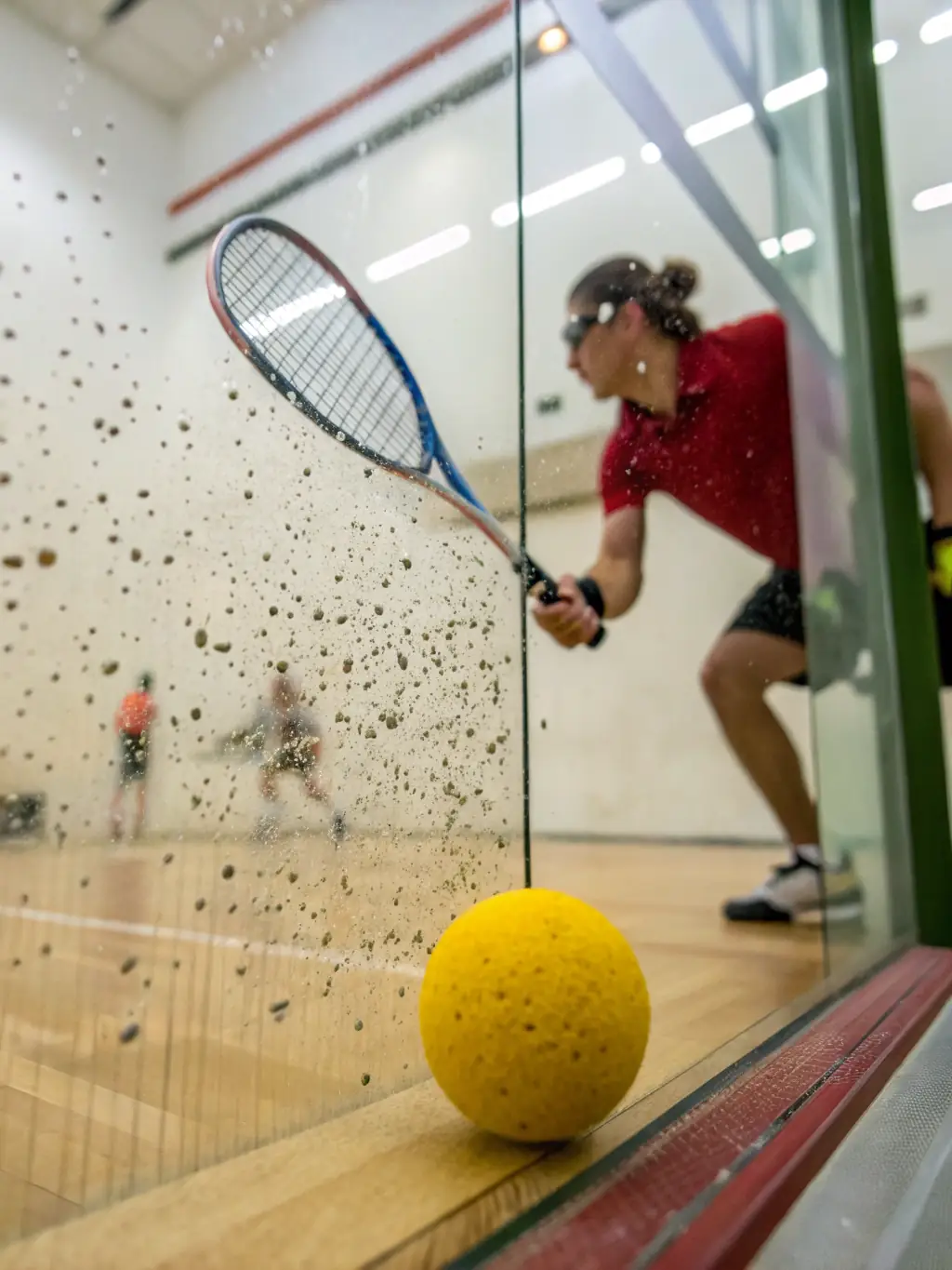 An action shot of a squash league match in progress at LAGORD TENNIS SQUASH, showcasing the intensity and fast-paced nature of the game.